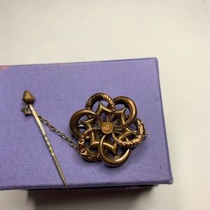 14k gold 1920s brooch, delicately crafted with pin on chain detail.